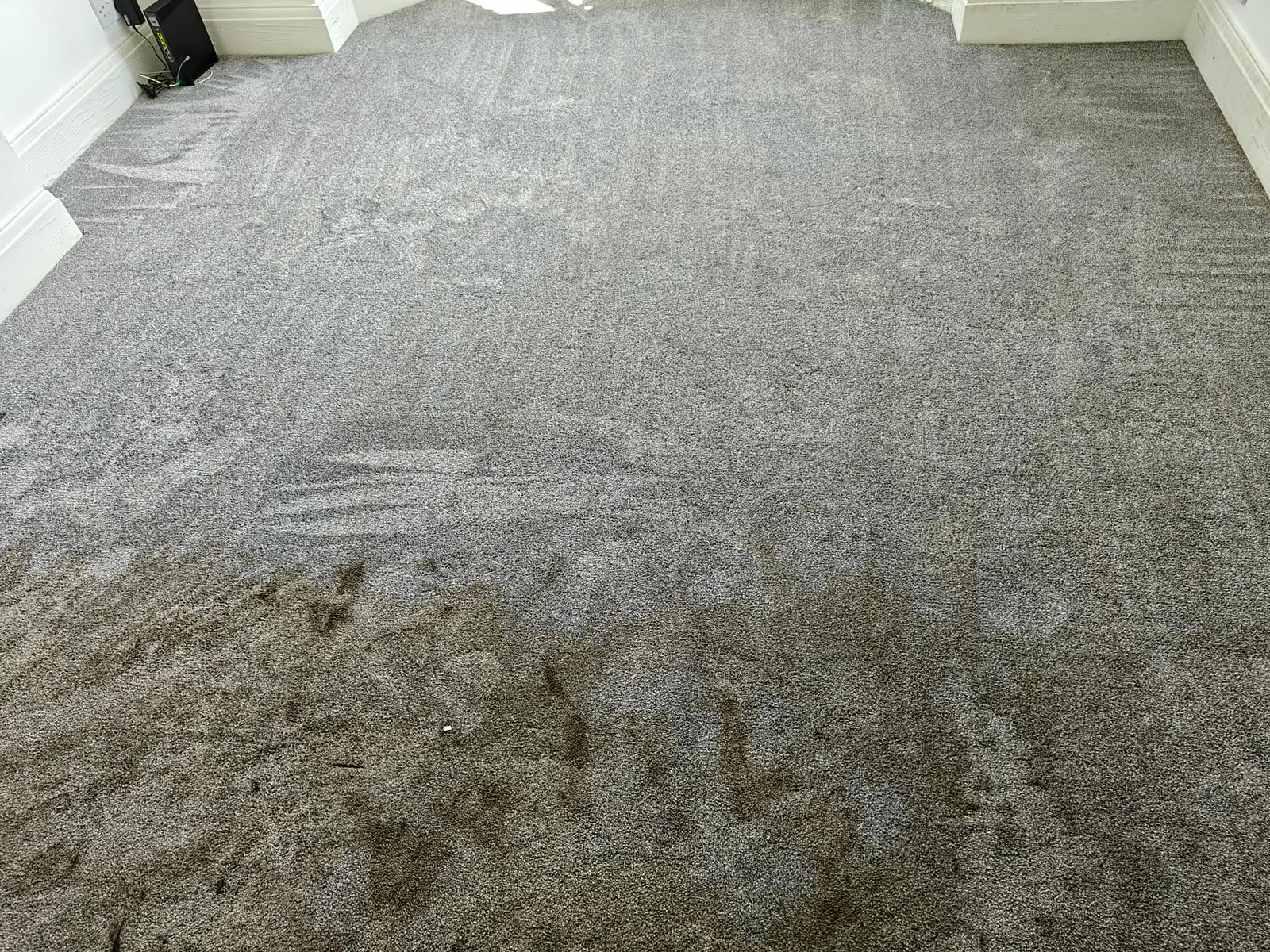 Heavy stains on a grey carpet before cleaning